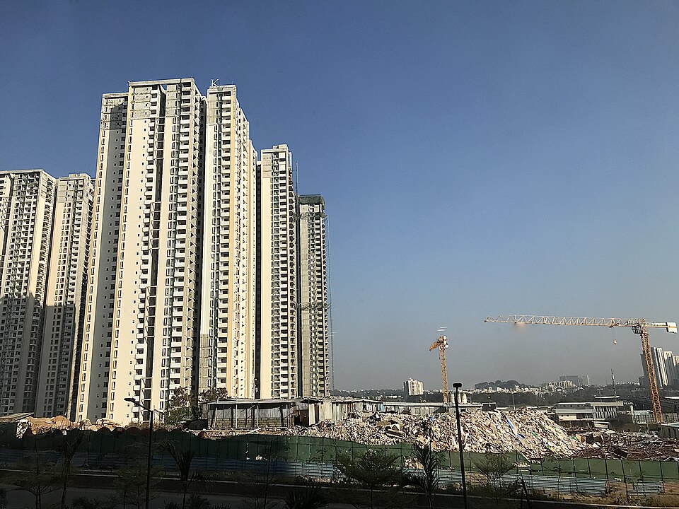 Residential buildings under construction with tower cranes in Hyderabad